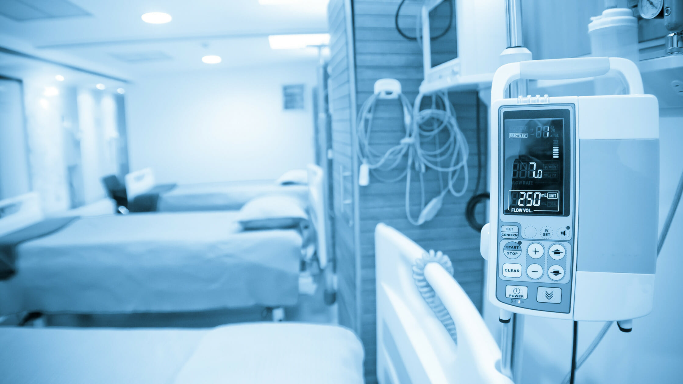 empty hospital bed with a monitor next to it