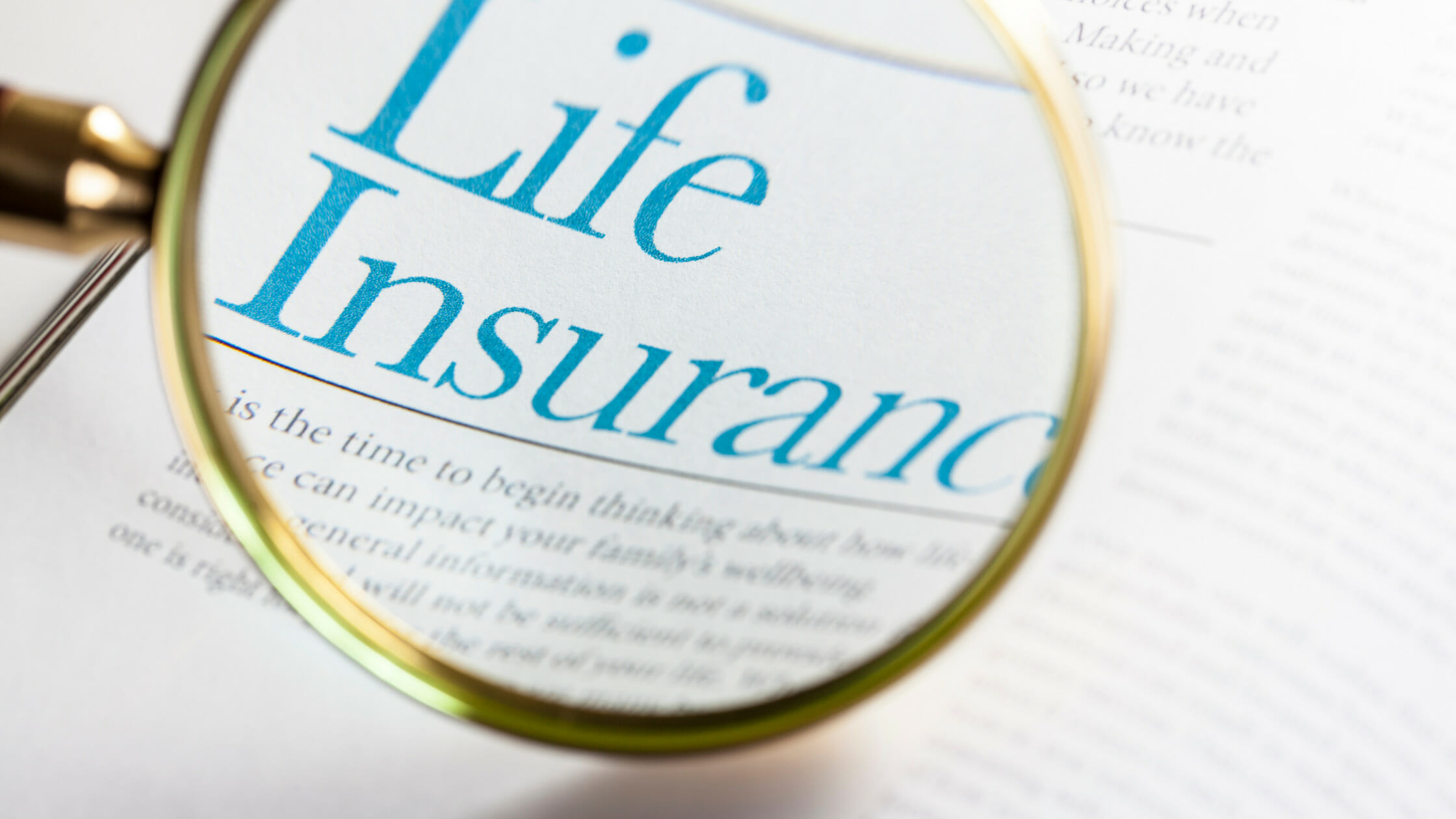 magnifying glass over the words "Life Insurance" on a document